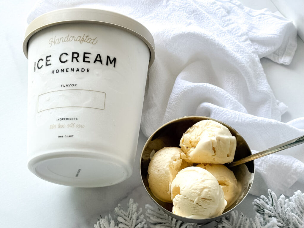 photo of Eggnog Ice Cream in a bowl next to a a container