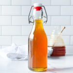 photo of honey syrup next to a jar of honey