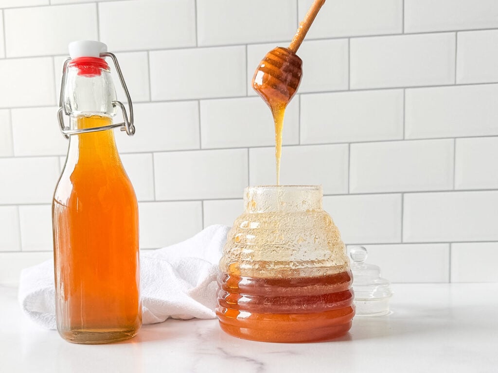photo of honey syrup next to a jar of honey
