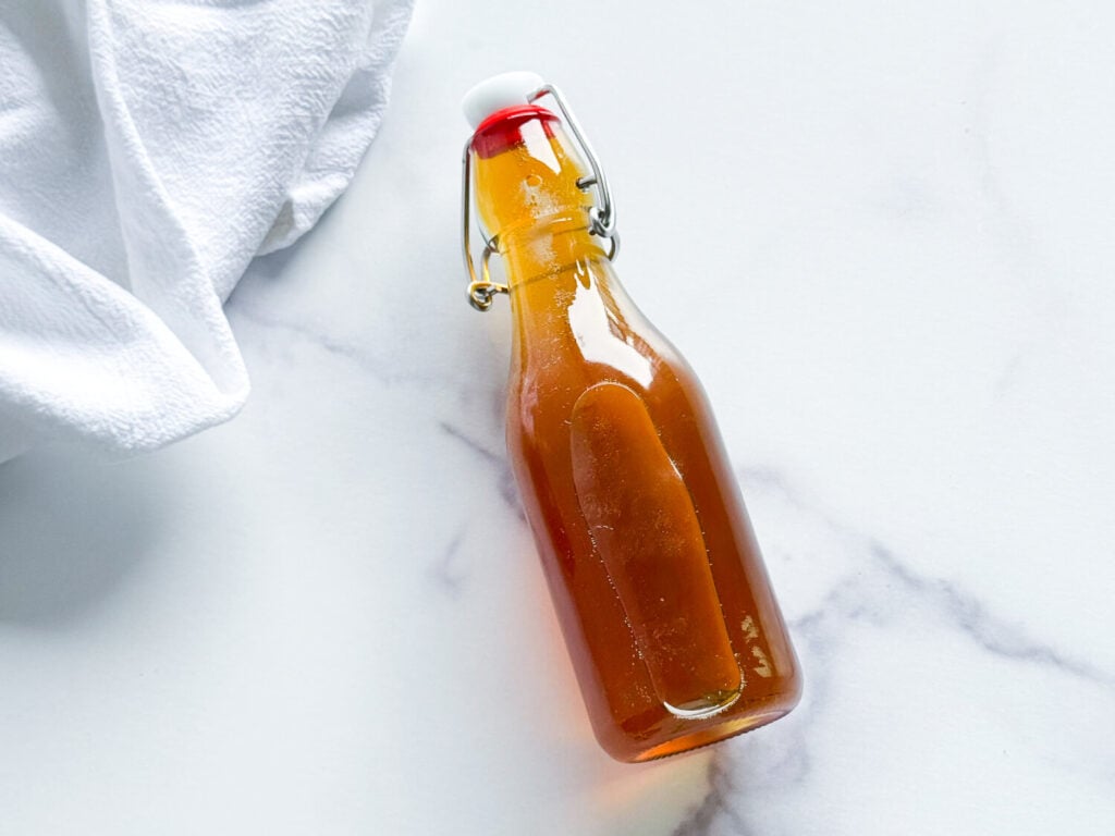 Overhead shot of honey syrup in an airtight container