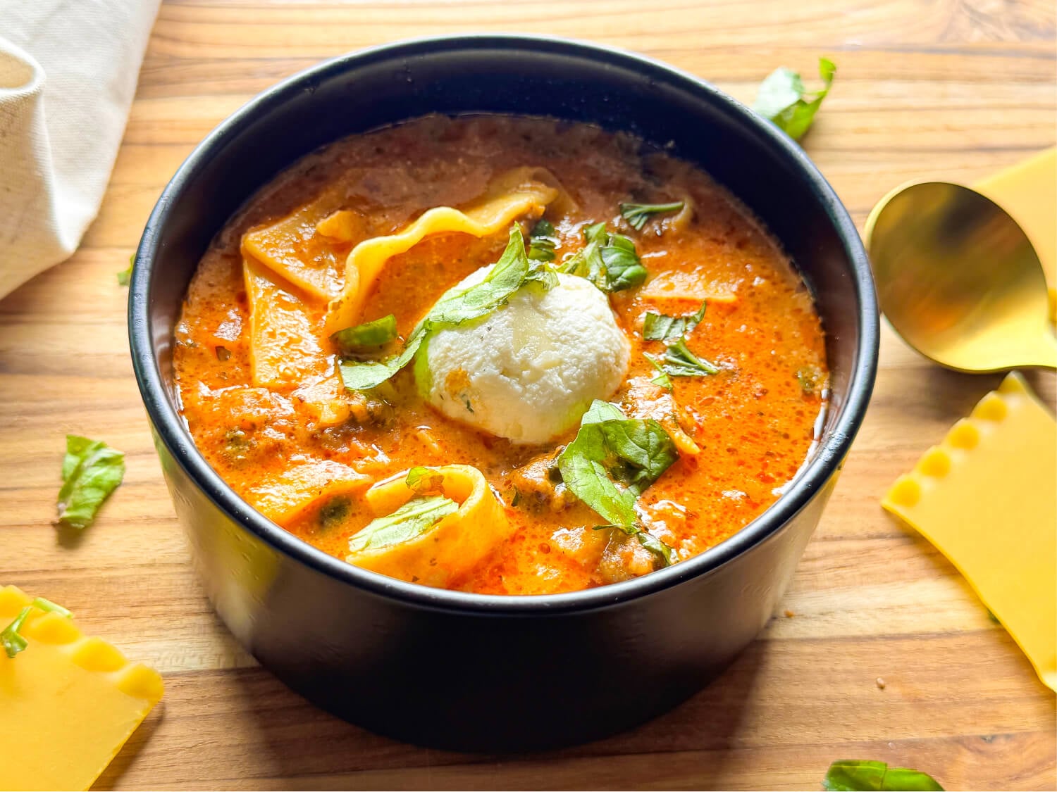 photo of lasagna soup in a black bowl