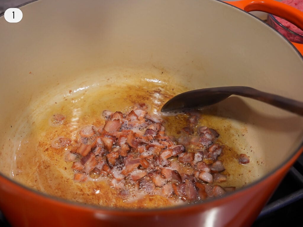 close up photo of bacon cooking in a dutch oven