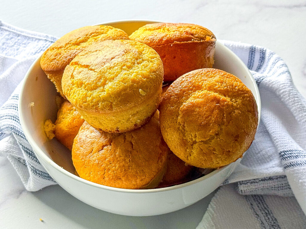 photo of baked Cornbread Muffins in a white bowl