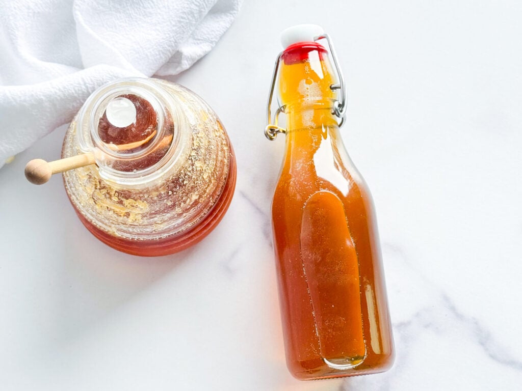 photo of honey syrup next to a jar of honey
