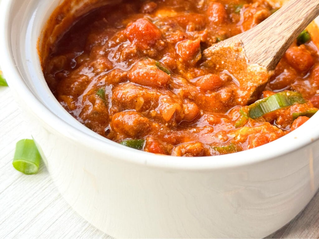 close up photo of homemade chili in a white bowl