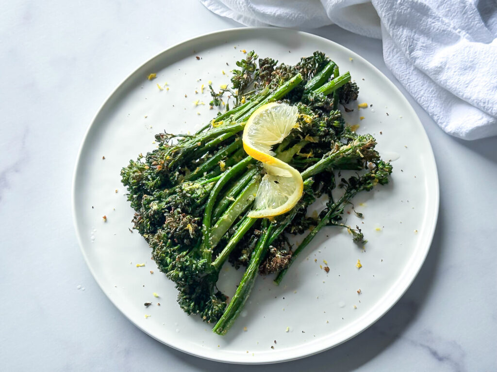 photo of cooked air fryer Broccolini with a lemon twist on top