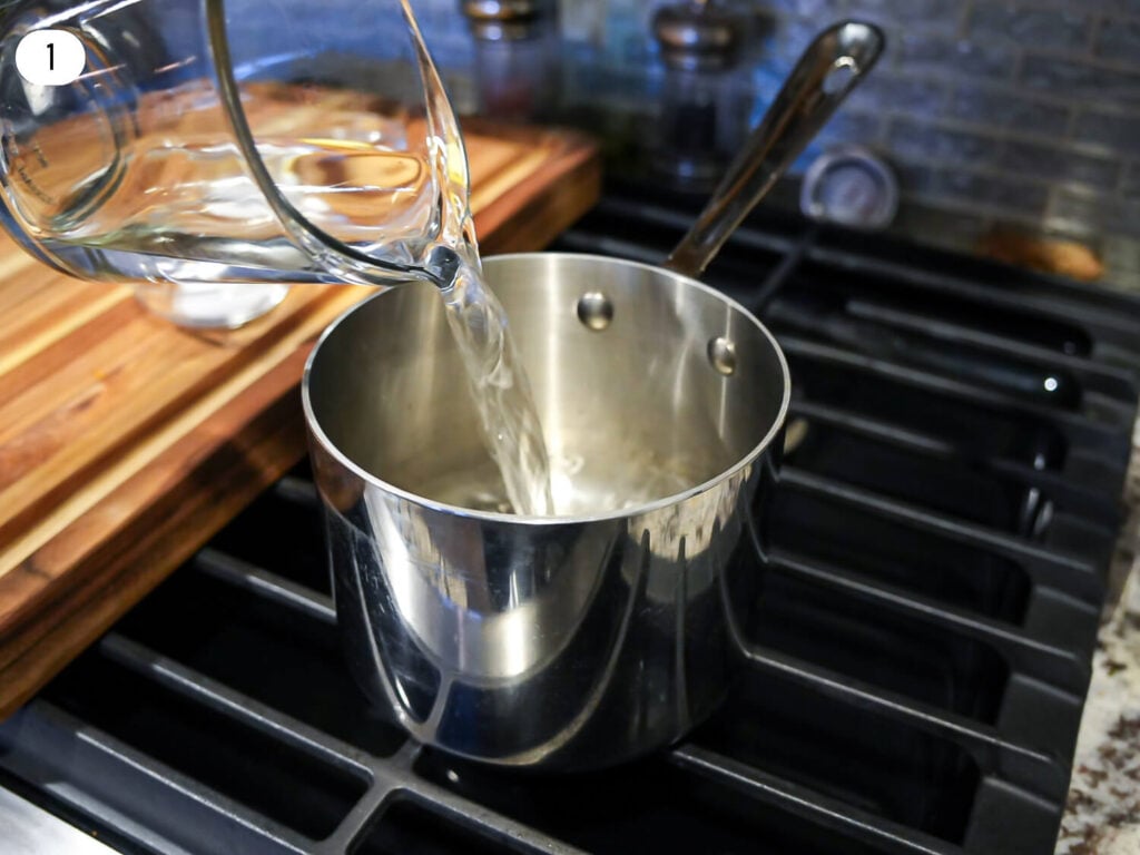 Photo of water being poured into a stainless steel sauce pan