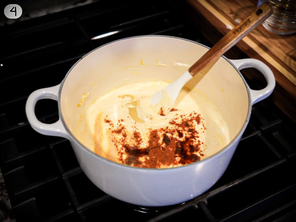 Step 4 - Photo of adding seasonings to melted cheese in pot