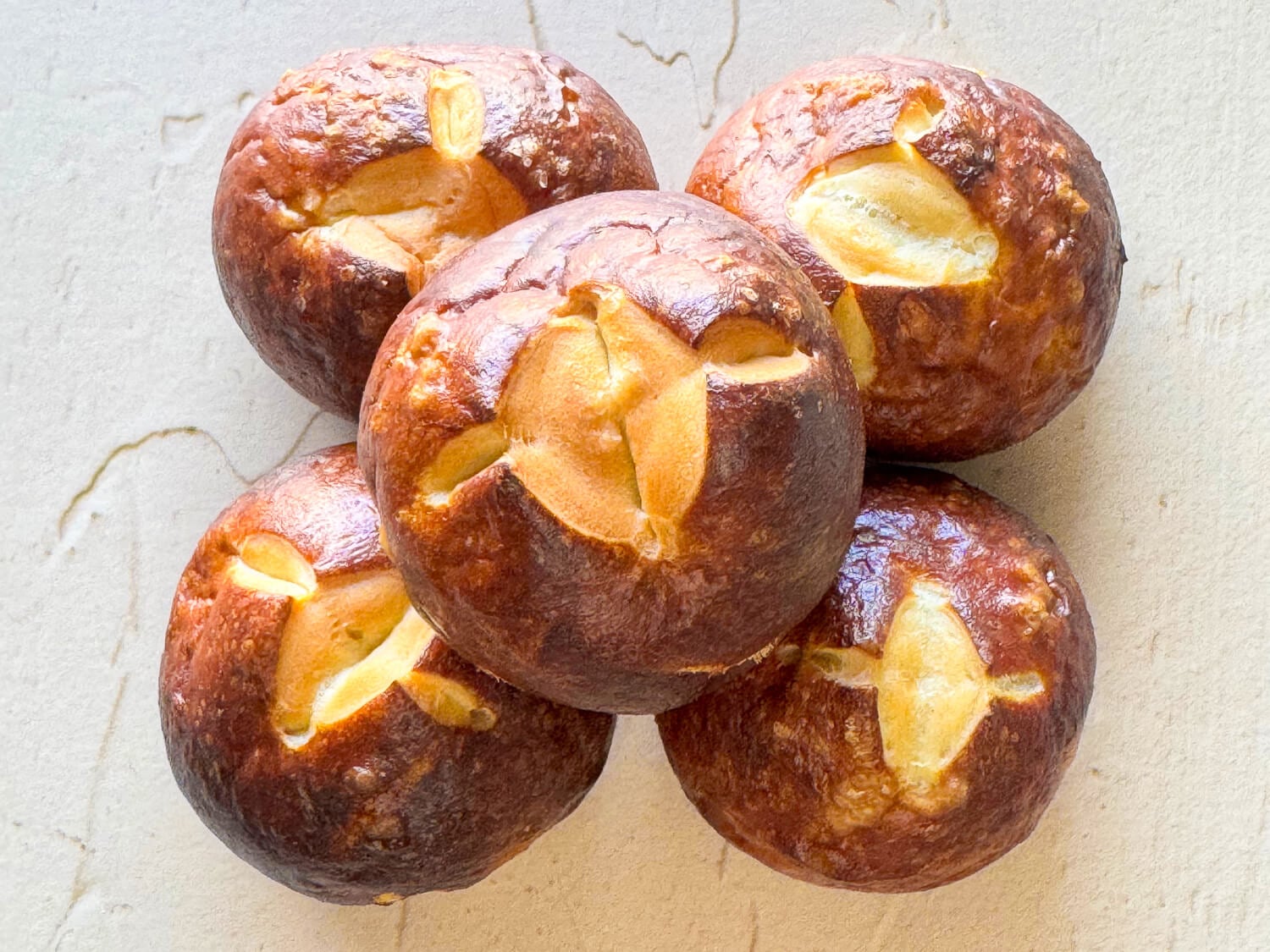 a photo of five pretzel buns stacked