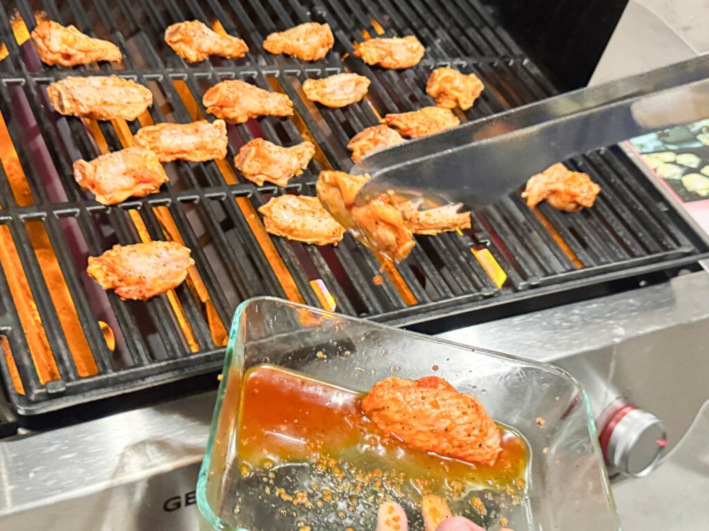 action photo of a grill in a tong being placed on the grill
