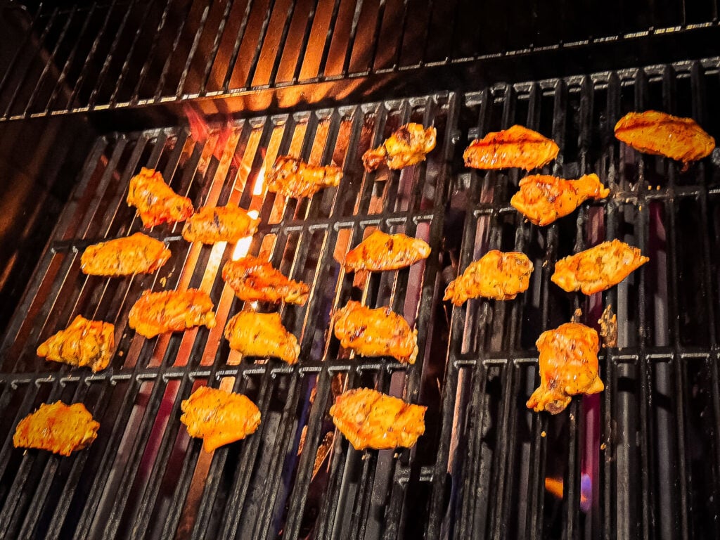 action photo of fire under grilled chicken wings