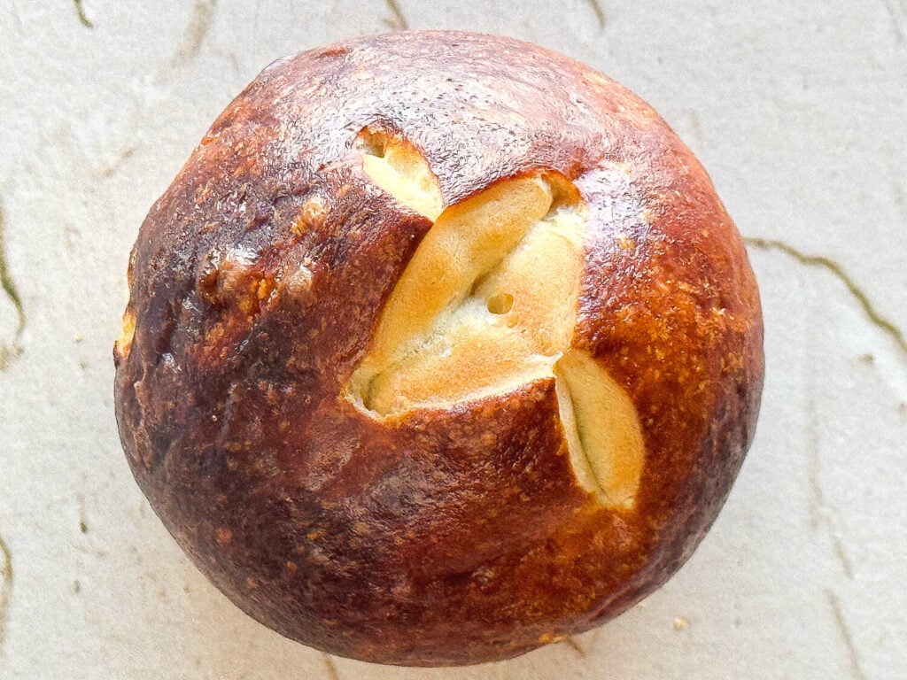 close up photo of a single pretzel bun