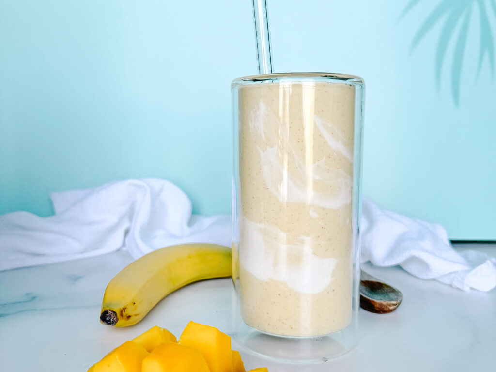 photo of a mango smoothie against a blue background