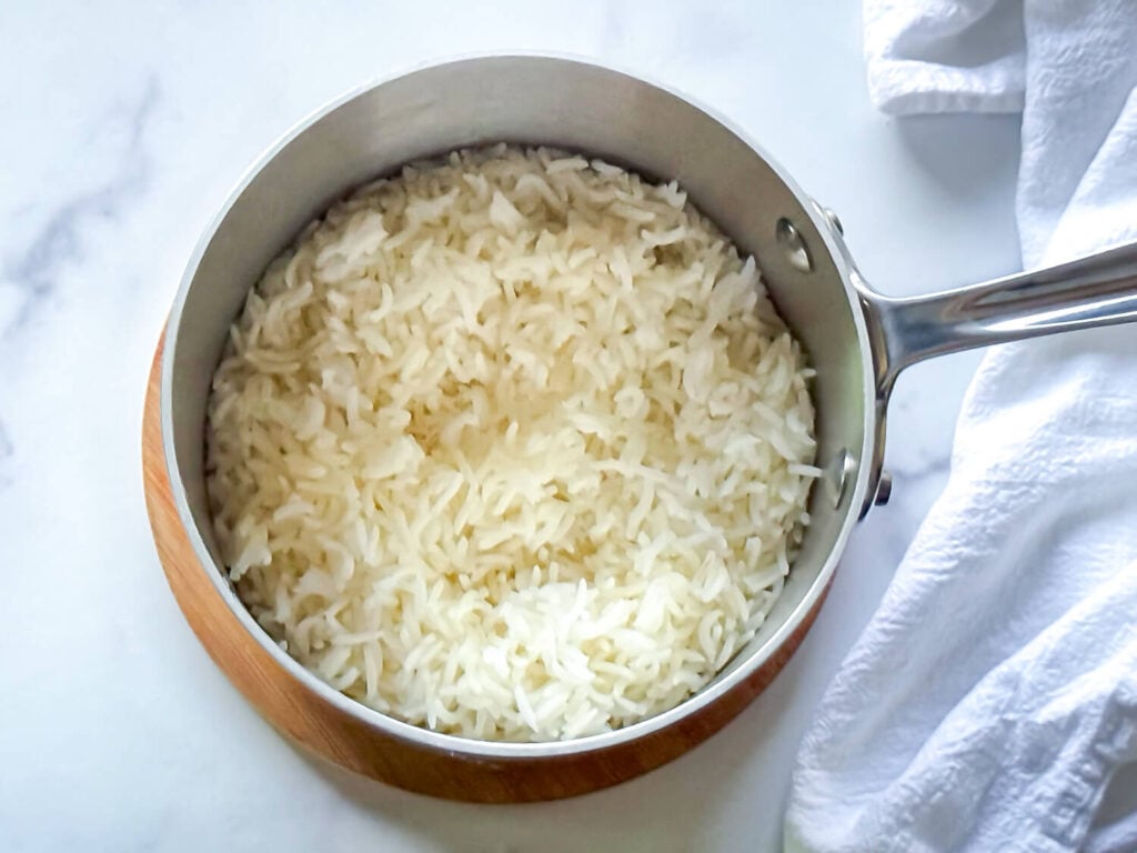 overhead photo of cooked white rice in a sauce pan