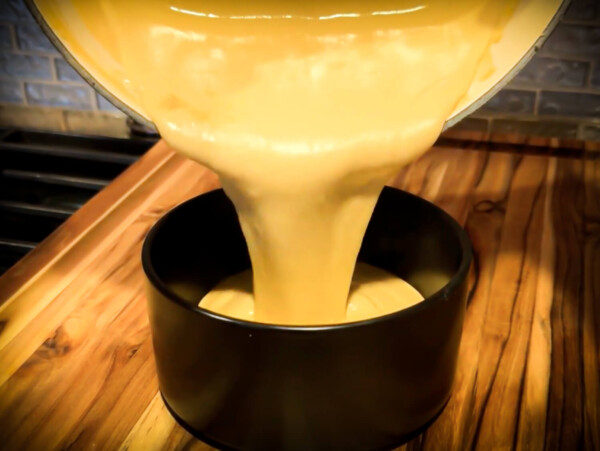 photo of beer cheese being poured into a bowl from a pot