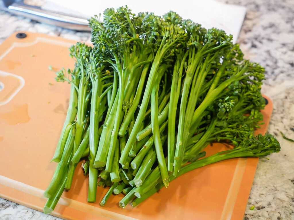 photo of cleaned and chopped Broccolini on a cutting board