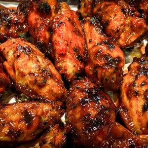 photo of grilled chicken wings drizzled in bbq sauce