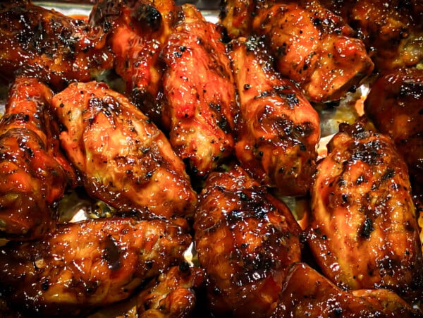 photo of grilled chicken wings drizzled in bbq sauce