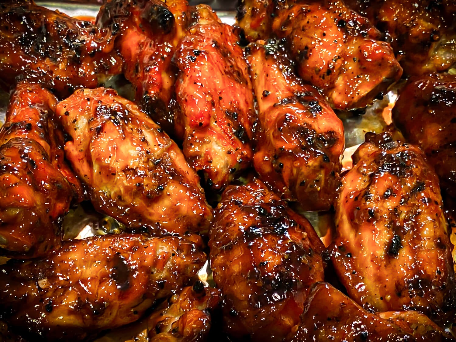 photo of grilled chicken wings drizzled in bbq sauce