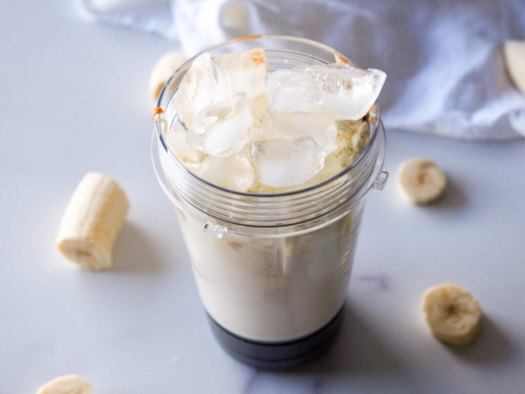 photo of ingredients in a blender cup to make a peanut butter smoothie