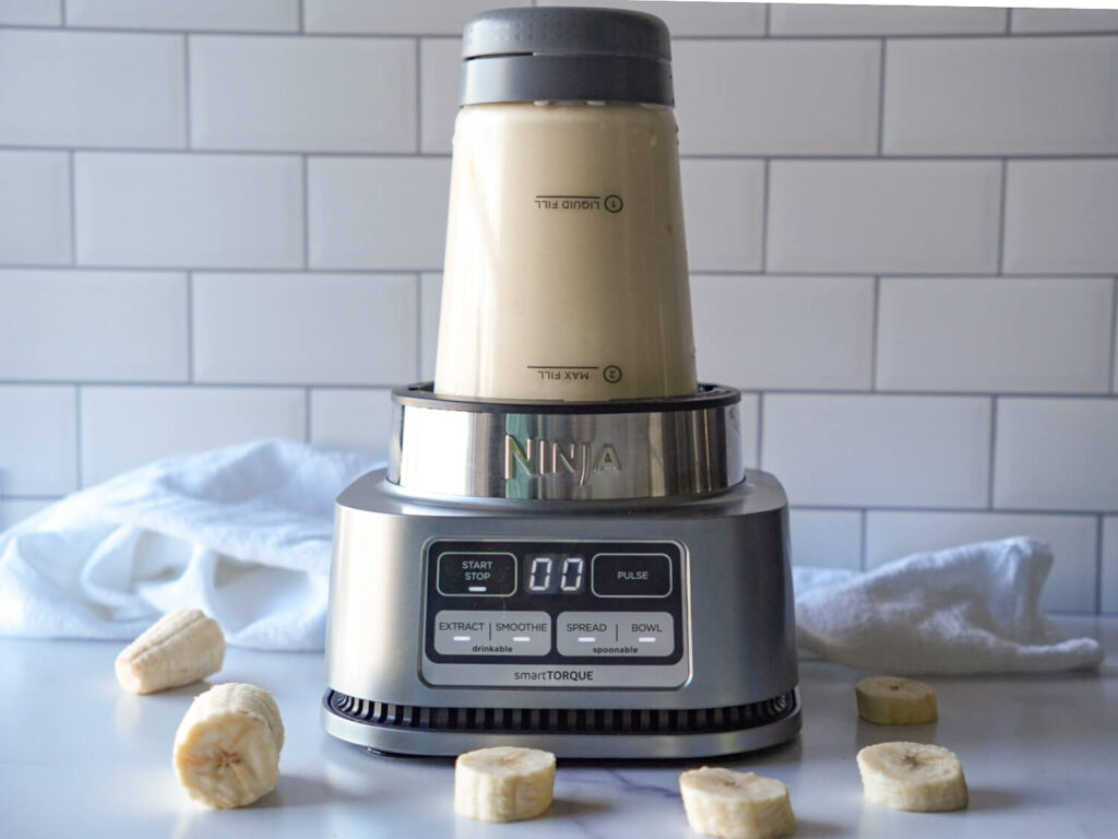 photo of peanut butter banana smoothie blending in a blender