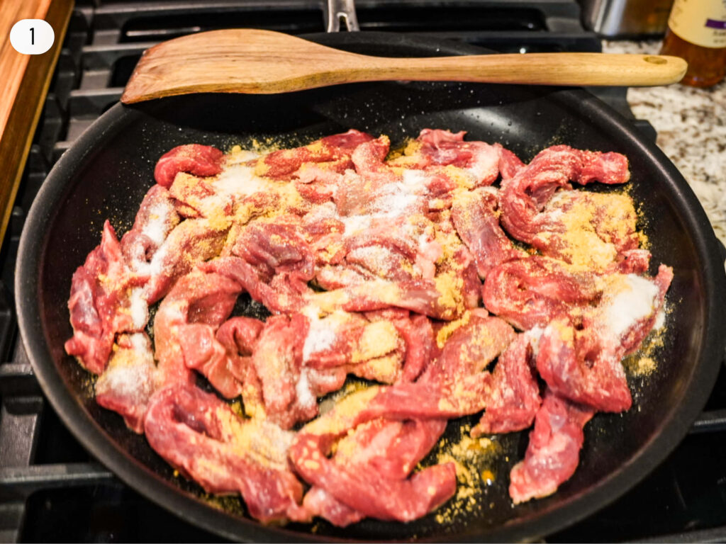 photo of seasoning on top of sirloin in the pan