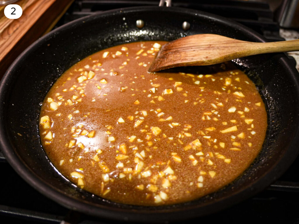 photo of a wooden spoon resting on a sauce pan to make gravy