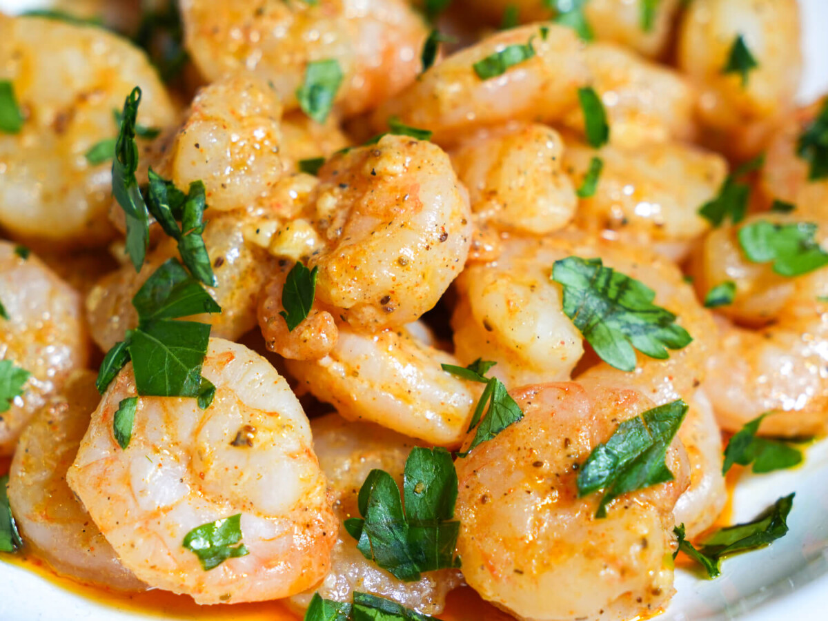 Close up photo of pan seared shrimp with parsley garnish