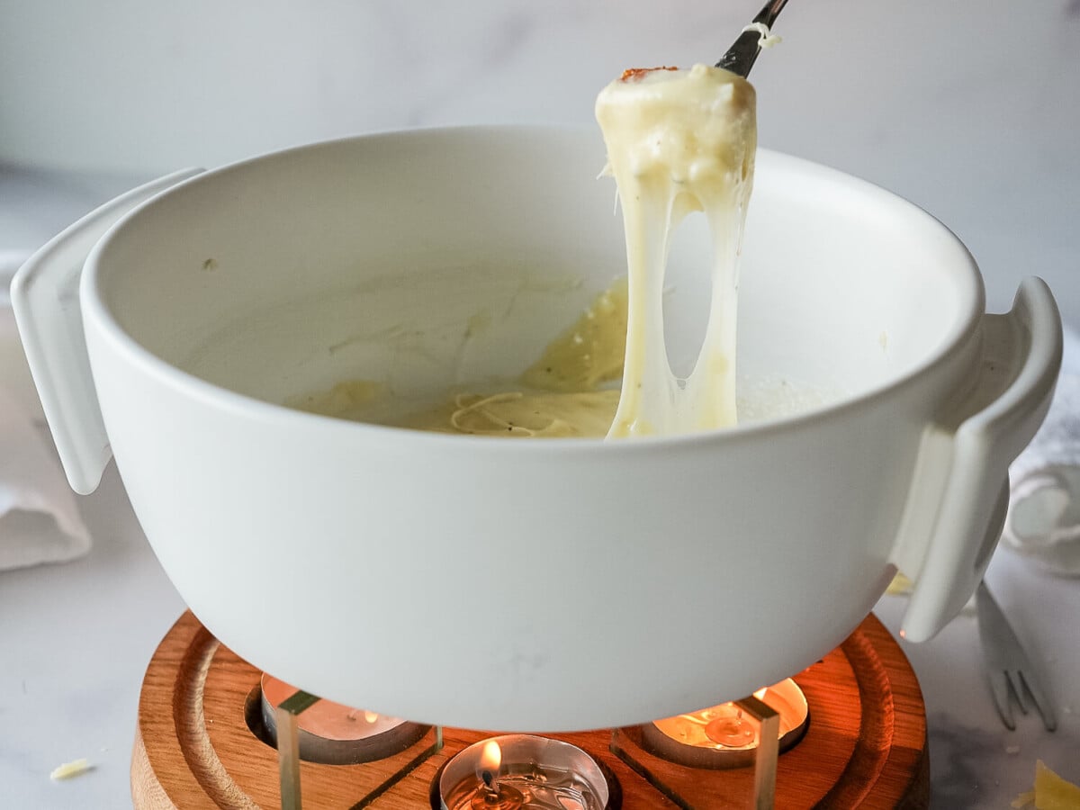 HERO - Cheese Fondue in a white fondue pot