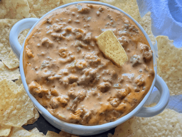 HERO HEADER Sausage Cheese Dip in a white bowl surrounded by tortilla chips