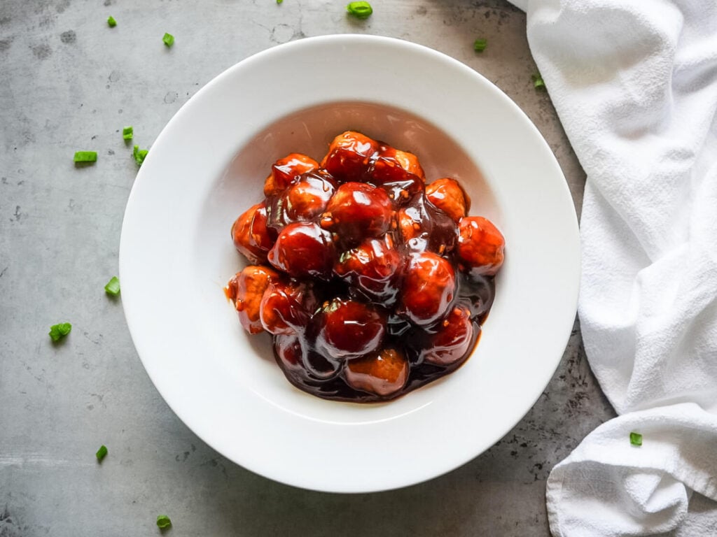 Overhead photo of Honey Garlic Meatballs in a white ceramic bowl
