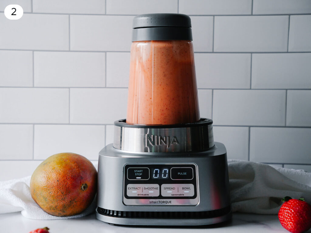 Step 2 photo of strawberry mango smoothie ingredients blending