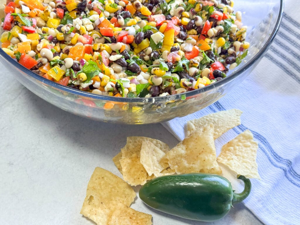 photo of Black Eyed Pea Salad tortilla chips and a jalapeno