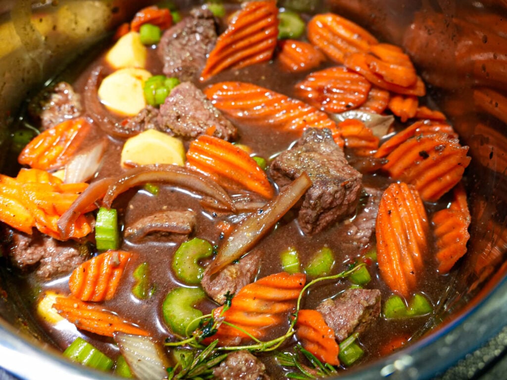 photo of Slow Cooker Beef Stew in the middle of the cooking process before veggies turn tender