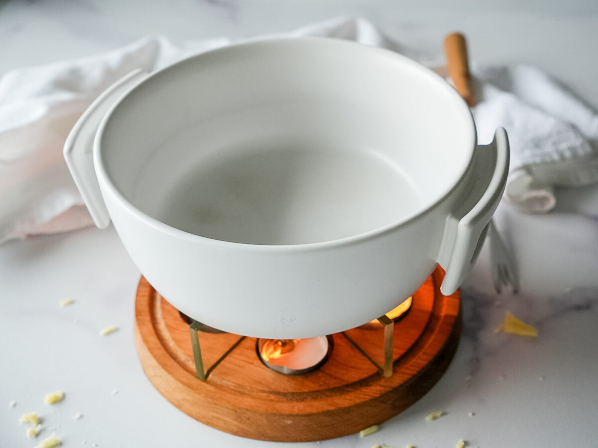 photo of a white fondue pot over candles