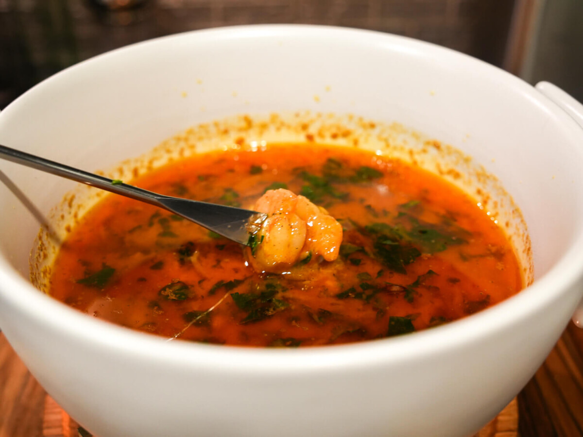 photo of shrimp being dipped in Lemon Garlic Butter Sauce