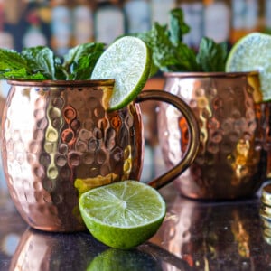 photo of two. Kentucky Mules with limes and a gold shaker top
