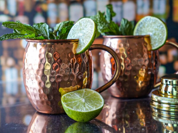 photo of two. Kentucky Mules with limes and a gold shaker top