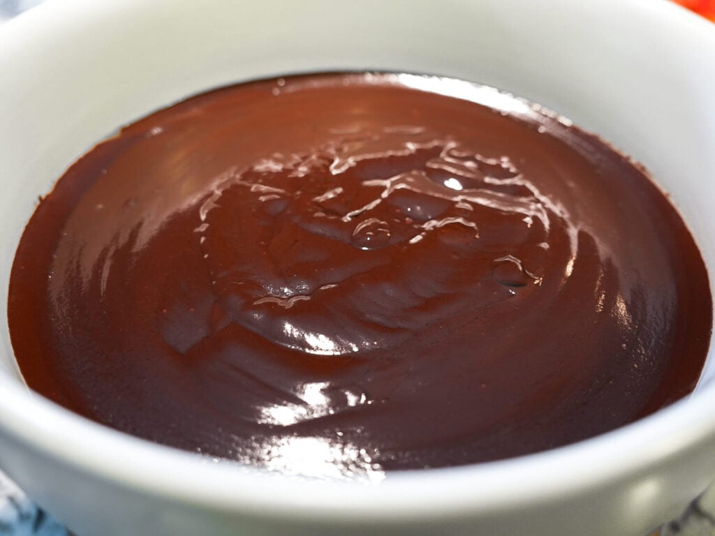 side view photo of glossy chocolate fondue