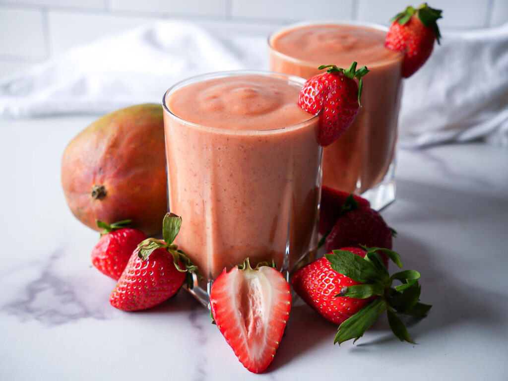 side view photo of two strawberry mango smoothies