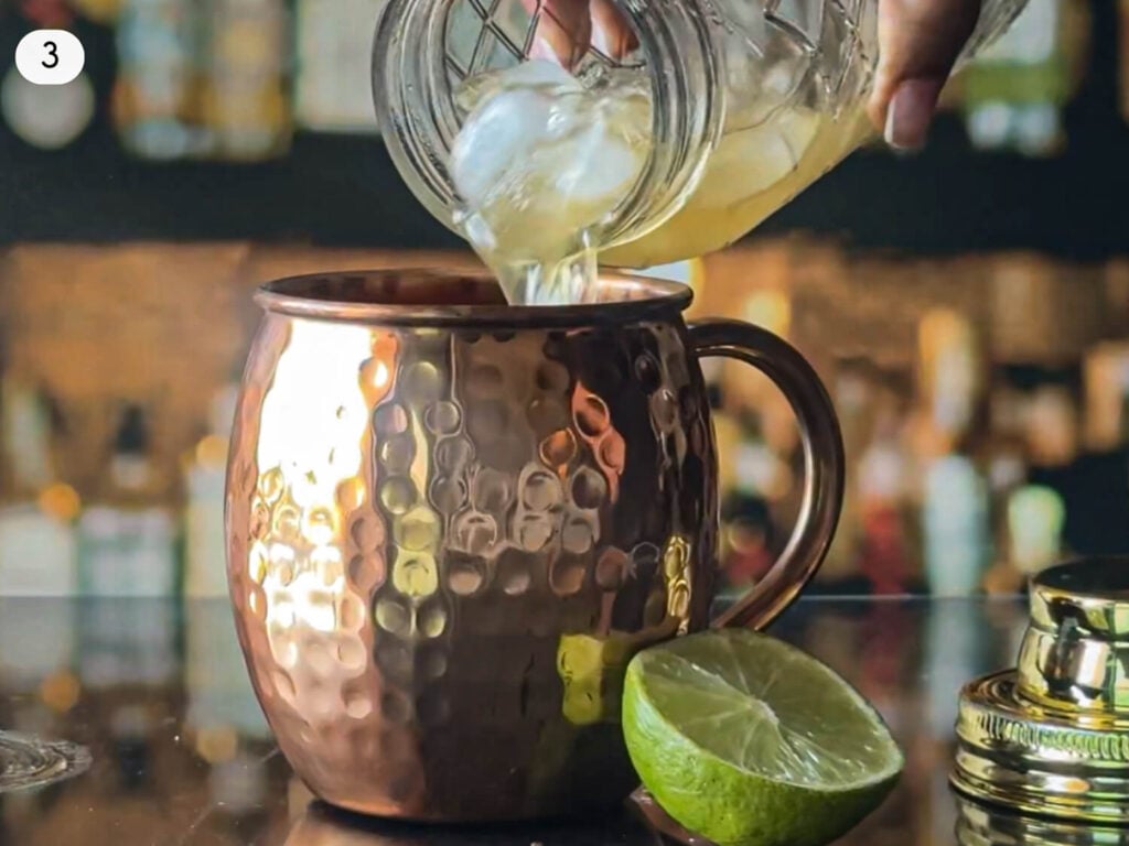 step 3 photo of pouring mixed ingredients from a cocktail shaker