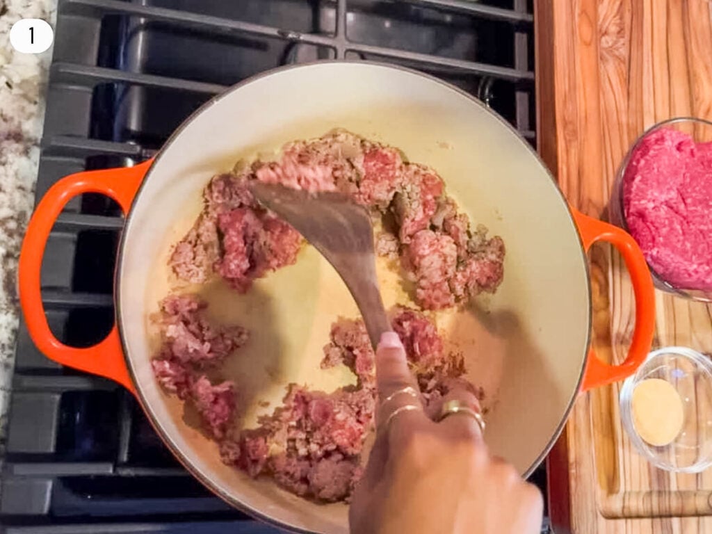 step one Photo of pork sausage browning in a dutch oven