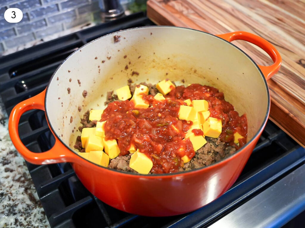 step three photo of Velveeta and salsa being added to the pot of brown meat