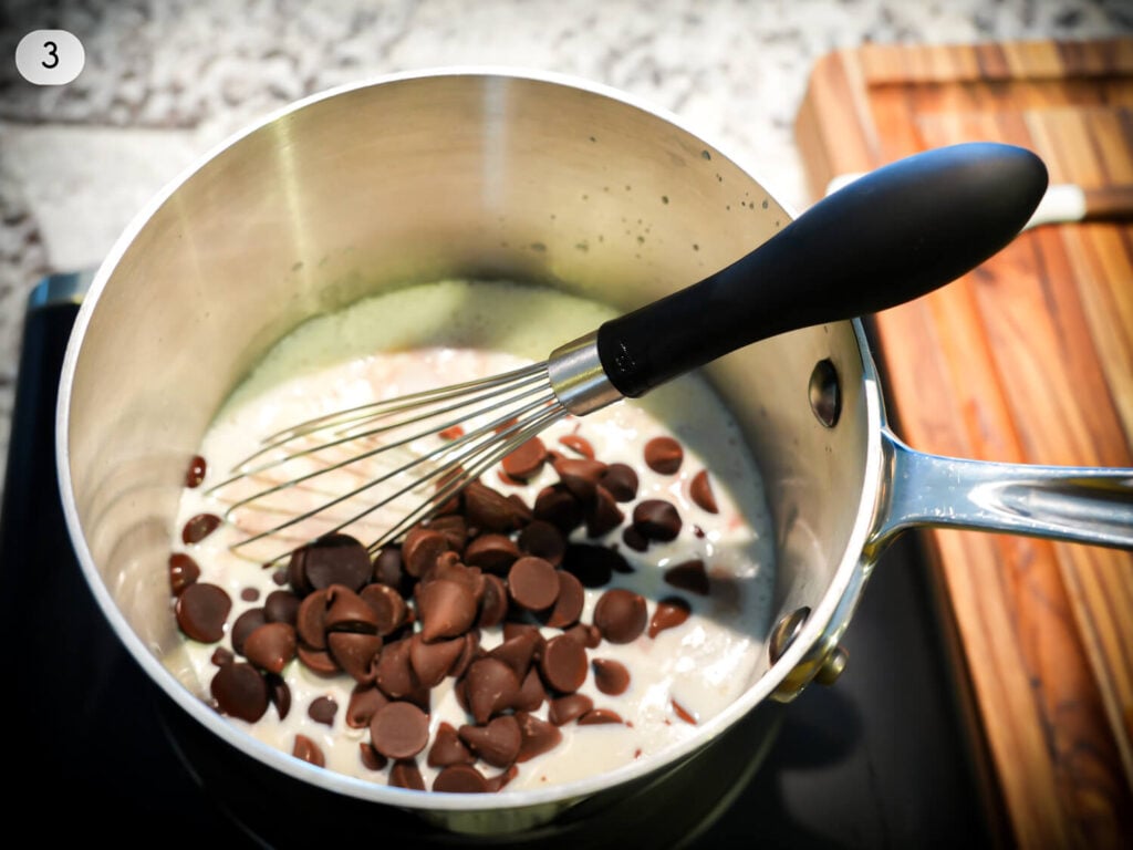 step three photo of chocolate in the sauce pan with warm heavy cream