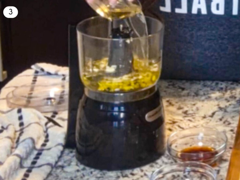step three photo showing olive oil being poured into a food processor