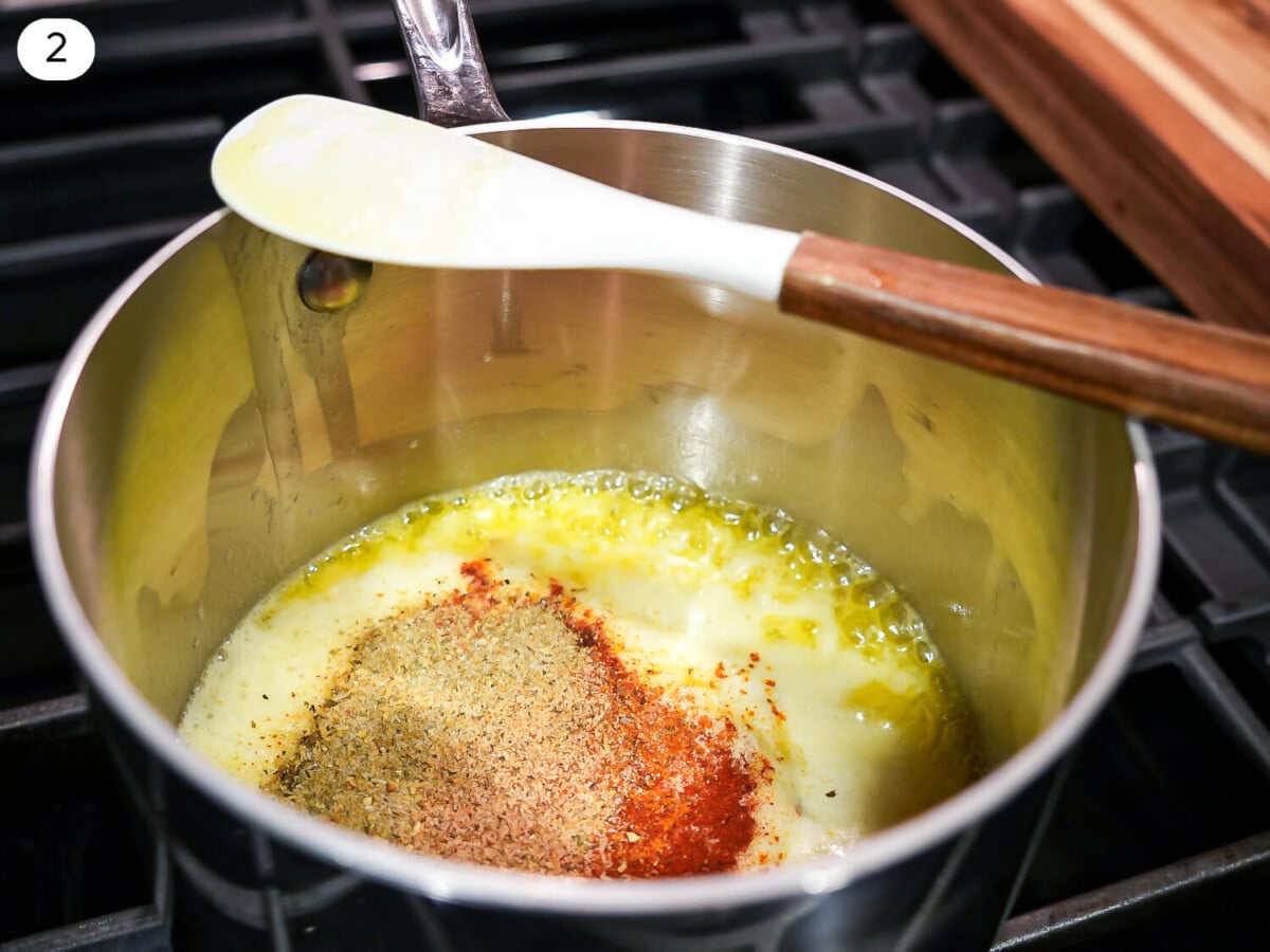 step two photo of Lemon Garlic Butter Sauce seasonings in sauce pan with butter