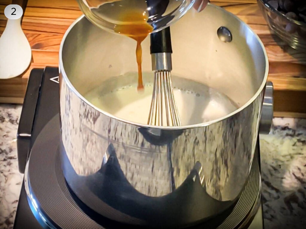 step two photo of vanilla extract being poured into a sauce pan