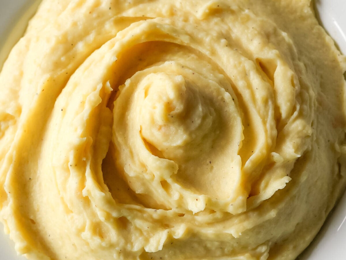 Close up overhead photo of Garlic Mashed Potatoes in a white bowl
