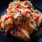 Close up photo of Italian Dressing Chicken with onions and peppers on top