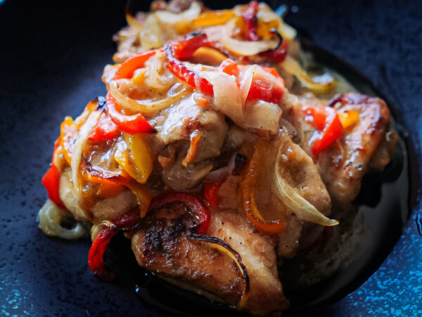 Close up photo of Italian Dressing Chicken with onions and peppers on top